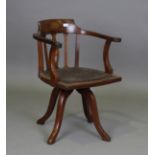 An Edwardian mahogany and palmette inlaid revolving tub back desk chair, on four downswept legs,