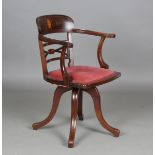An Edwardian mahogany and fan patera inlaid revolving tub back desk chair, on four downswept legs,