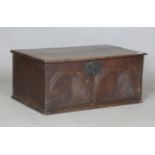 An 18th century oak box, the front carved with two bold palmettes, height 33cm, width 75cm, depth