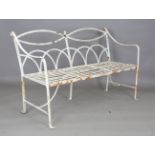 A 19th century white painted wrought iron garden bench with arched strap back and slatted seat,