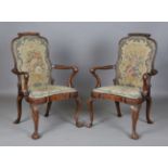 A fine pair of early 20th century Queen Anne style walnut framed elbow chairs, the seat and back