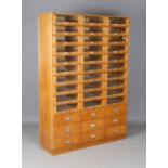 A late 20th century oak and beech haberdashery cabinet, fitted with an arrangement of glass-