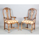 A pair of early 20th century French walnut pierced splat back elbow chairs with drop-in seats, on
