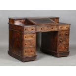 A mid-Victorian burr walnut twin pedestal desk with gallery back and sloping hinged lid, height