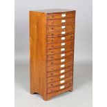 A modern hardwood bowfront chest of fourteen drawers, height 93cm, width 42.5cm, depth 30cm.Buyer’