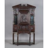 A late Victorian Jacobean Revival stained oak hall stand, carved with flowers and lunettes, height