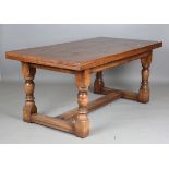 A 20th century Jacobean style solid oak draw-leaf refectory dining table, height 78cm, extended