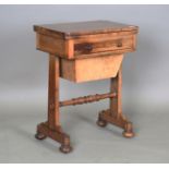 A Victorian rosewood work table, the top hinged to reveal a surface inset with leather above a