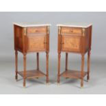 A pair of early 20th century French marble-topped bedside cabinets with ormolu mounts and ceramic-