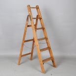 An early 20th century pine stepladder, height 140cm, width 31cm.Buyer’s Premium 29.4% (including VAT