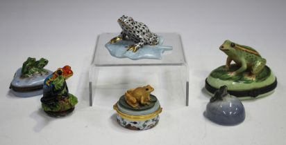 A Herend porcelain frog with black scale decoration, seated on a blue leaf, length 7.5cm, together