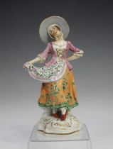 A pearlware figure of a dancing girl, early 19th century, raised on a gilt enriched scroll moulded