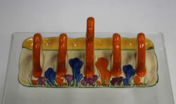 A Clarice Cliff Bizarre Autumn Crocus pattern toast rack, the shaped rectangular base with five