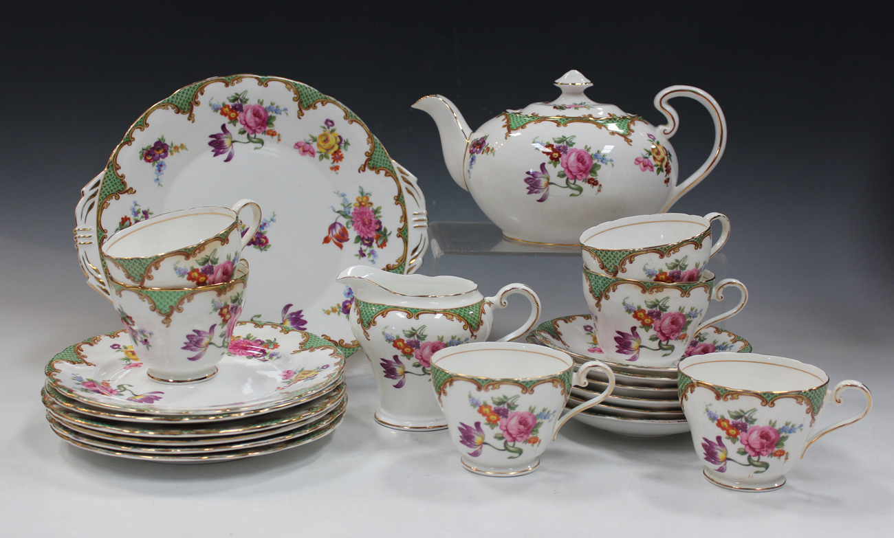 An Aynsley part tea service, decorated with floral groups beneath scroll edged green scale