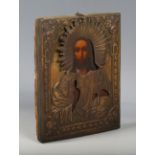 A 20th century Continental painted icon depicting Jesus Christ, mounted with an embossed brass