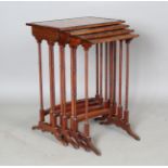 An Edwardian mahogany quartetto nest of occasional tables, each with an oval amboyna reserve and