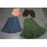 A group of Victorian undergarments, including a blue shot silk skirt, a green watered silk skirt,