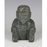 A pre-Columbian Olmec style carved green hardstone figure of a seated elderly man, possibly 900-