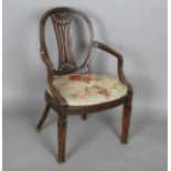 A late George III Neoclassical walnut framed elbow chair with a beaded frame and caned seat,