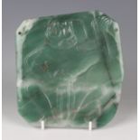 A pre-Columbian Olmec style carved apple green jade pectoral plaque, carved in low relief with a
