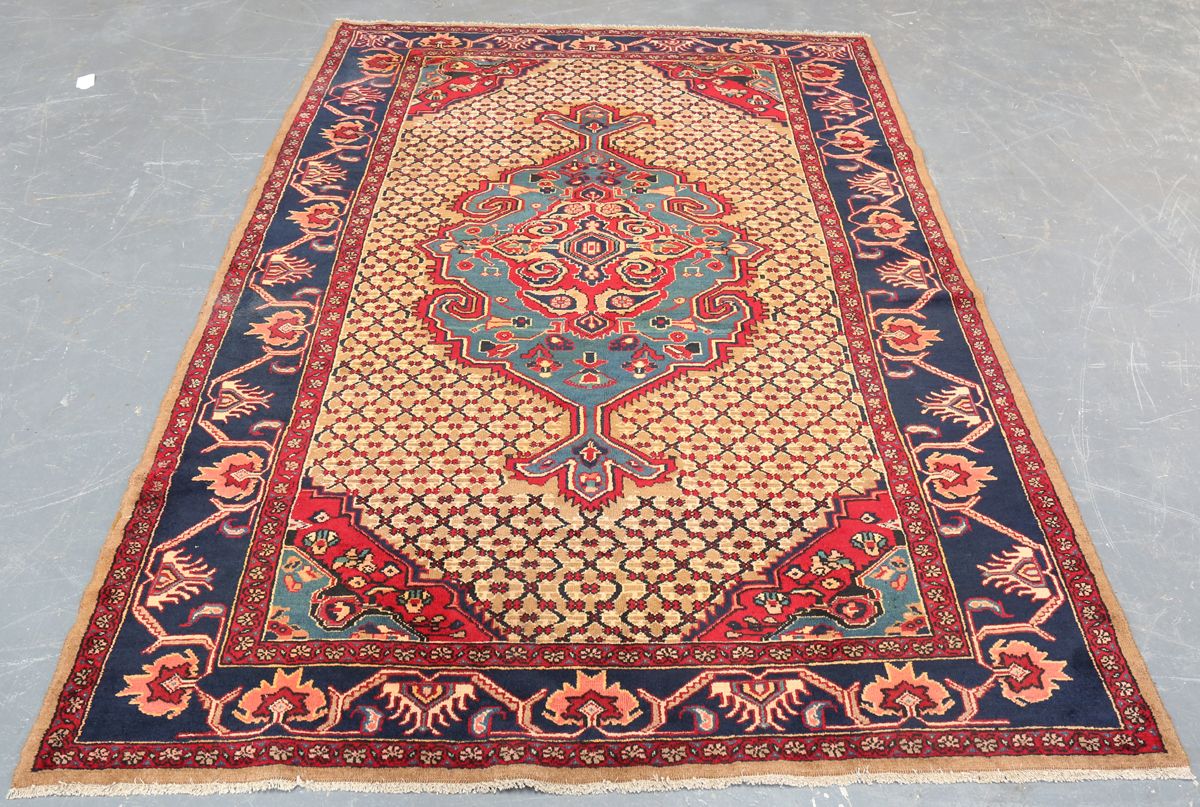 A Hamadan rug, North-west Persia, late 20th century, the sand-coloured field with a shaped