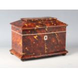 A Regency tortoiseshell twin-division tea caddy of bowfront sarcophagus form, raised on wooden bun