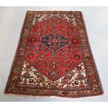 A Hamadan rug, North-west Persia, mid-20th century, the red field with a pole medallion, within a