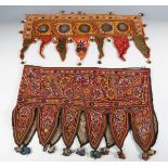 A group of Indian Kutch embroidered items, including two mirror work hangings, a bag, various panels