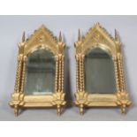 A pair of late 19th century Gothic Revival giltwood and gesso wall mirrors of arched architectural