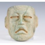 A large pre-Columbian Olmec style finely carved green hardstone mask, possibly 900-450 BC, with