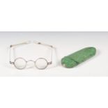 A George III shagreen spectacles case with hinged lid, containing a pair of silver spectacles,