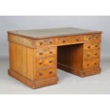 A mid-Victorian pollard oak twin pedestal desk, the top inset with leather and with a carved edge