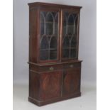 An early 20th century stained walnut bookcase cabinet, height 210cm, width 122cm, depth 47cm.Buyer’s