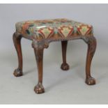 An early 20th century George III style mahogany stool with carved acanthus leaf cabriole legs,