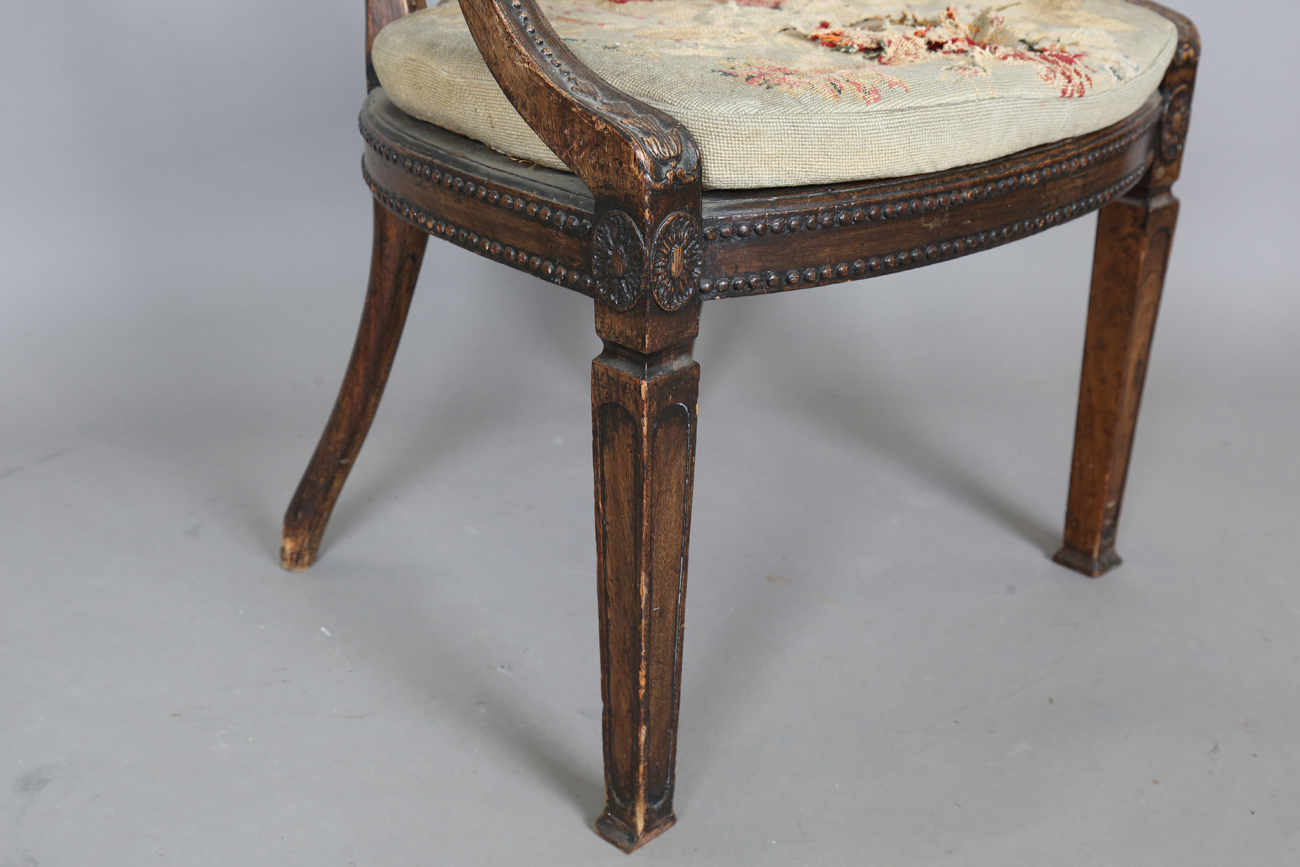 A late George III Neoclassical walnut framed elbow chair with a beaded frame and caned seat, - Image 3 of 11