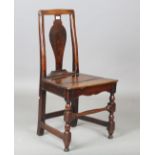An early 18th century Welsh oak and ash vase back side chair with a solid panel seat, height 93cm,