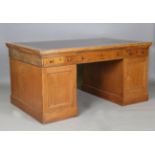 A Victorian pale oak twin pedestal partners desk, the top inset with gilt-tooled leather above a