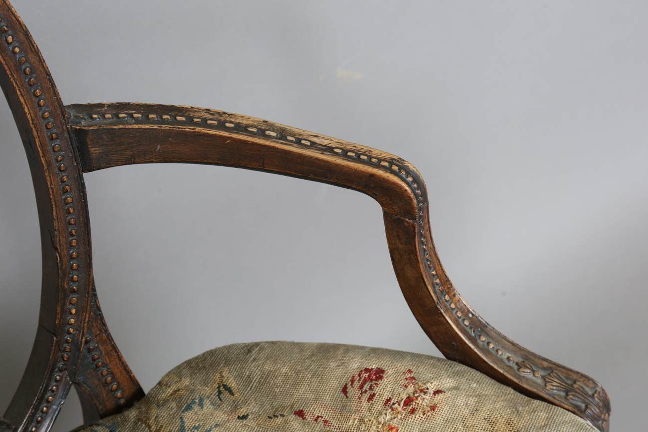 A late George III Neoclassical walnut framed elbow chair with a beaded frame and caned seat, - Image 6 of 11