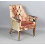 A William IV mahogany scroll arm library chair with buttoned leather upholstery, on turned legs