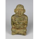 A pre-Columbian Olmec style carved green hardstone figure of a seated male, possibly 900-450 BC,