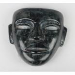 A pre-Columbian Teotihuacan style carved dark green and black hardstone mask, possibly 250-700 AD,