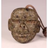 A pre-Columbian Olmec style carved mottled green hardstone transformation mask, possibly 900-450 BC,