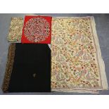 A group of mainly Indian textiles, including a finely embroidered black shawl, a cream silk panel,