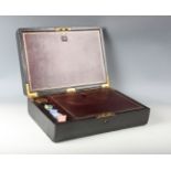An early 20th century black leather and gilt-tooled writing box with brass handle and fitted