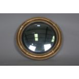 A 19th century gilt painted circular convex wall mirror, the rounded section frame with tulip cusps,