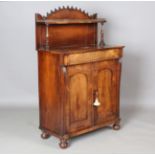 An early Victorian rosewood chiffonier, the galleried shelf back above a concealed frieze drawer and