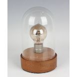 A Marconi valve light bulb, detailed 'R 7308', height 9.7cm, on a wood plinth with Perspex dome