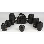 A Nikon D7100 camera body and a small group of Nikon lenses, comprising Nikkor 18-105mm 1:3.5-5.6