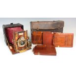 An early 20th century Sanderson mahogany and gilt brass quarter-plate hand camera with red leather