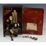 A lacquered and black enamelled brass monocular microscope by W. Watson & Sons Ltd, with rack and